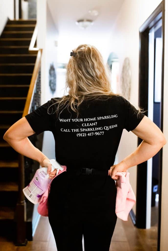 Back of a Sparkling Queens shirt reading Want your home sparkling clean? Call the Sparkling Queens